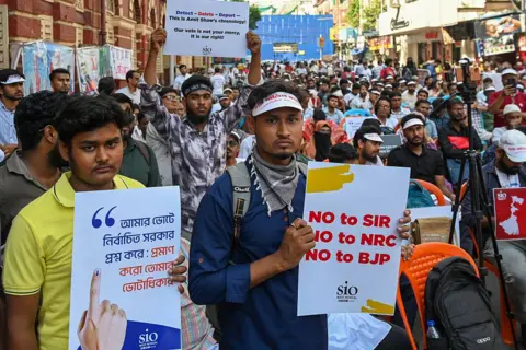 Hindustan Times via Getty Images People belong to a a protest rally demanding the restoration of voting rights for those removed from the voter list during Special Intensive Revision (SIR) process roll out in Kolkata