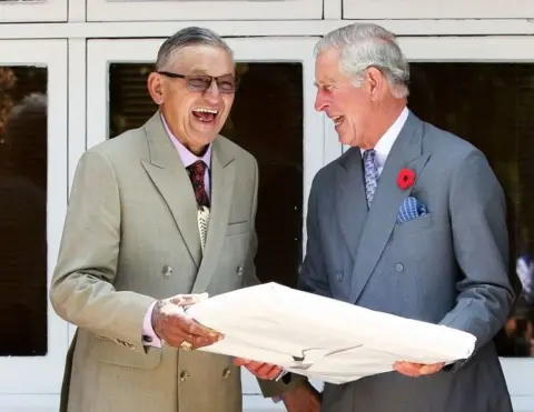 AFP Then-Prince Charles and King Tuheitia laugh as they exchange a gift 