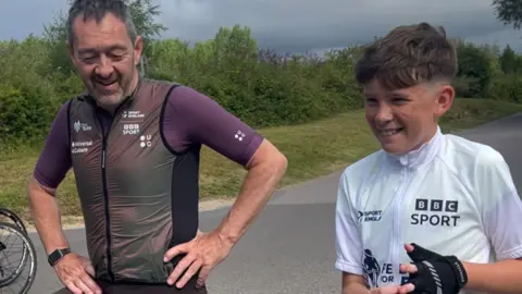 Family photograph Dexter and Chris Boardman on their bikes during the former Olympian's Pedal to Paris event.