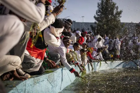 Michele Spatari / AFP People from the Oromo community splash themselves with water to celebrate 'Irreecha' in Addis Ababa.