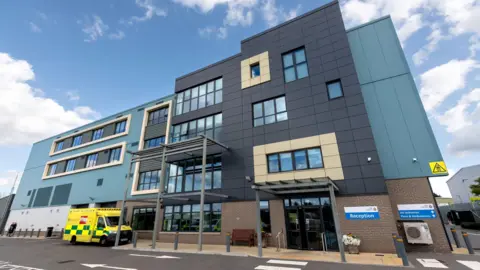 South East Coast Ambulance Service An office of an ambulance service. There is an ambulance vehicle parked outside.