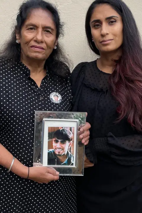 Ayshea Buksh/BBC older woman and young woman looking to camera holding a framed photo