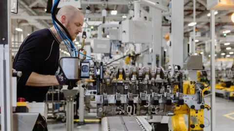 PA/ Jaguar Land Rover A worker at the JLR engine factory at Wolverhampton.
