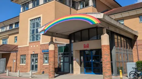 A rainbow over the entrance to a hospital site