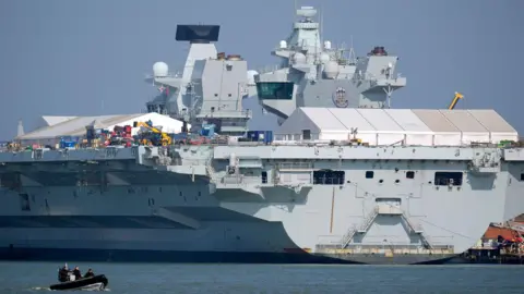 The Royal Navy aircraft carrier HMS Prince of Wales in dock at Portsmouth harbour, Hampshire.