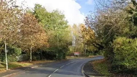Google Image of a bend in the road lined with trees on Chain Caul Way in Preston