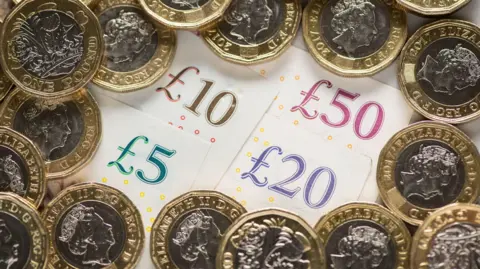 PA Media UK five pound, ten pound, twenty pound and fifty pound notes with one pound coins