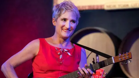 Jill Sobule, wearing a red top, plays the City Winery in New York City on 8 September 2018. 