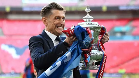 Crystal Palace chairman Steve Parish smiles while holding the FA Cup