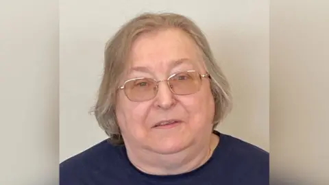 Dora Shergold Dora Shergold with short hair, glasses and a t-shirt