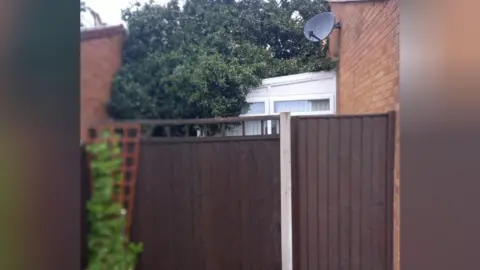 The remains of a large tree which collapsed on to a bungalow during a storm.