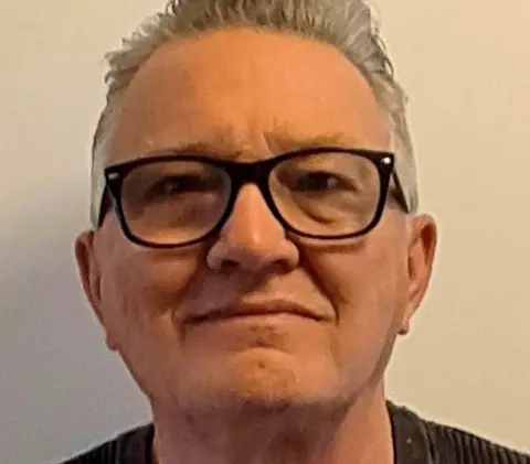 Kevin Jones Kevin Jones wearing glasses and a black jumper.