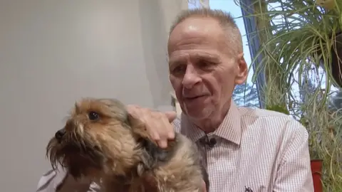 Michael Sullivan holds his dog