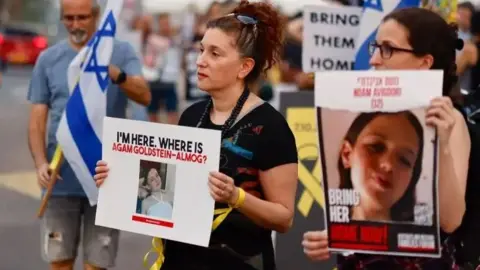 Protesters in Tel Aviv hold placards calling for the release of people kidnapped by Hamas (28 October 2023)