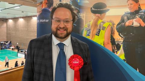 A picture of Matt Storey who is Cleveland's new PCC wearing a red rosette