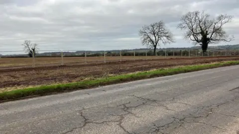 Land surrounded by a fence where homes will be built 