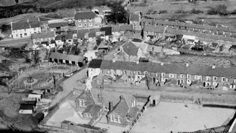 Gelligaer Historical Society An old black and white photo showing houses an a park in Troedrhiwfuwch 