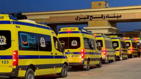 Reuters Egyptian ambulances wait on the Egyptian side of the Rafah crossing with Gaza, in Rafah, Egypt (2 February 2026)