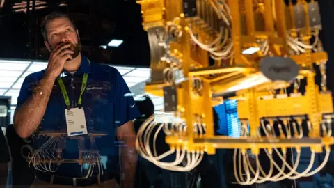 A man looking at a quantum computer