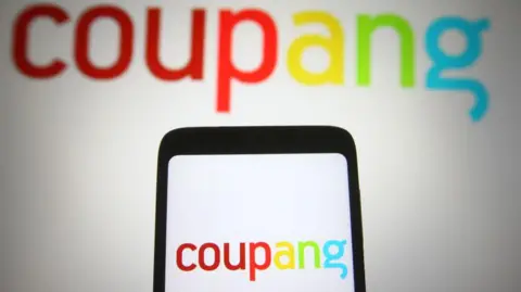 Getty Images Coupang logo on mobile phone screen against a white background