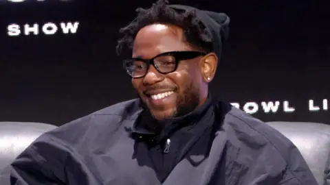 Getty Images Kendrick Lamar sat smiling