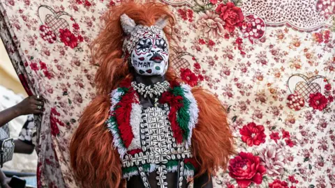 John Wessels/AFP Someone dressed up in a traditional costume for Senegal’s famous Fake Lion Show at a cultural event at Ngor beach in Dakar – Wednesday 5 June 2024