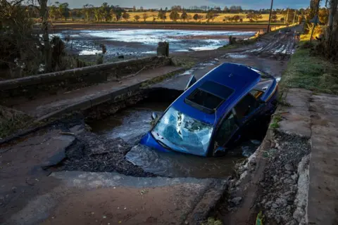 Getty Images A car is seen sliding on a bridge after yesterday's heavy rain on October 21, 2023 in Dundee, Scotland.