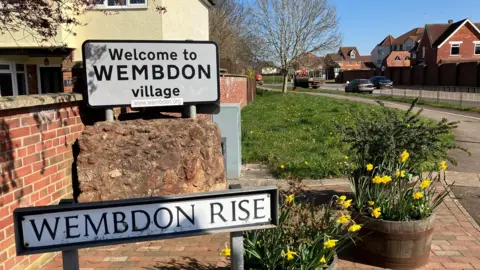 A sign saying welcome to Wembdon village.