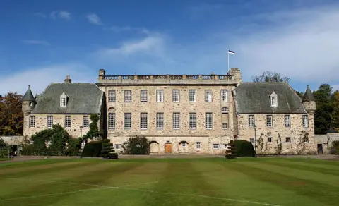 Getty Images An old three-storey school building with turrets with a grass lawn