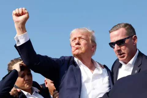 Getty Images Republican presidential candidate former President Donald Trump is rushed offstage during a rally on July 13, 2024 in Butler, Pennsylvania. 