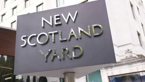 New Scotland Yard sign outside Met Police HQ in London