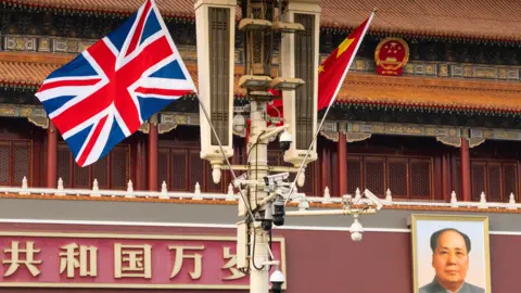 Reuters The National flag of China and the British Union Jack flutter next to the Tiananmen Gate, with a portrait of late Chinese Chairman Mao Zedong placed in the background