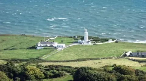 St Catherine's Point, Isle of Wight - onshore lighthouse standing on downswith sea stretching behind.