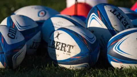 SNS rugby balls on grass