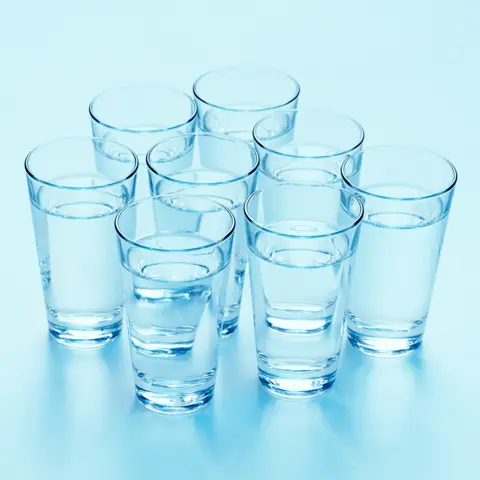 Getty Images Eight clear glasses filled pinch water, arranged successful a triangular statement connected a ray bluish background. Each solid is evenly spaced.
