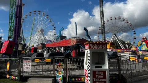 BBC A general view of an empty Goose Fair, Nottingham, with rides and Ferris Wheels in the background 