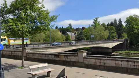 a screengrab of Tay Street in Perth, the street is next to a river with a bridge going over it