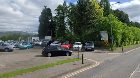 Google A car dealership by a road