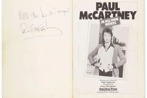 PA Media The inside front cover of a book. The pages are cream and on the inside there is a signed note from Sir Paul McCartney. On the other side there is a black and white image of Sir Paul McCartney and the headline text Paul McCartney In His Own Words