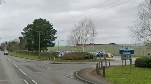 Road with sign saying HMP Prison Ranby to the right of the image
