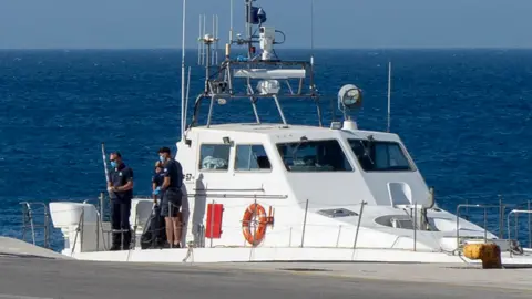 Getty Images A close up picture of a Greek coastguard ship with three people seen on the deck