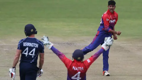 Nepal celebrate taking the wicket of Scotland's Richie Berrington in 2018