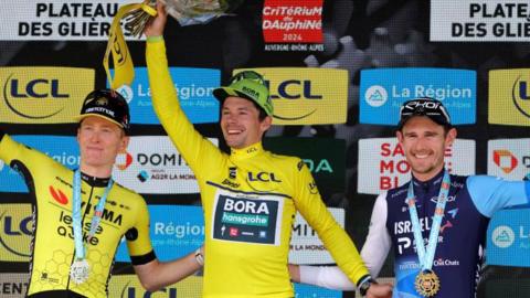 Matteo Jorgenson, Primoz Roglic and Derek Gee on the podium after finishing as the top three at the 2024 Criterium du Dauphine