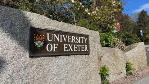 Exeter University sign on a wall