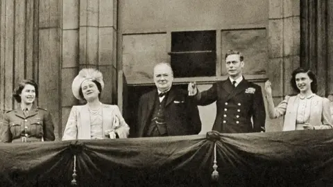 Getty Images Prime Minister Winston Churchill on the balcony of Buckingham Palace alongside the Royal Family (with the then Princess Elizabeth, on the left) on 8 May 1945