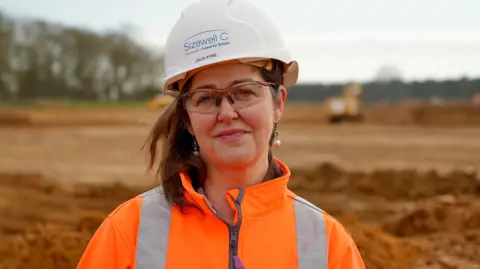 Martin Giles/BBC Julia Pyke standing on the main construction site for Sizewell C 