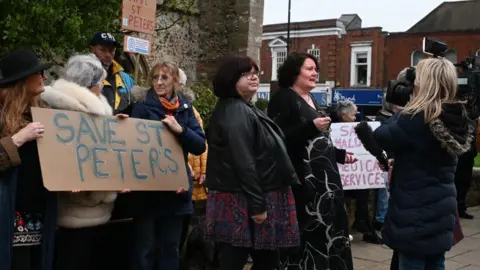 Save Maldon's Medical Services A group of protestors hold up signs reading "Save St Peters"