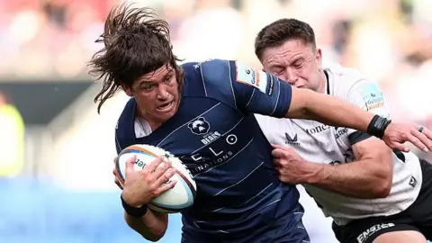 Benhard Janse van Rensburg holds off an opponent as he runs with the ball for Bristol Bears
