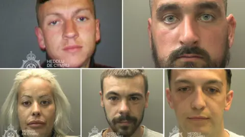 South Wales Police A composite image showing custody images of the five defendants. 