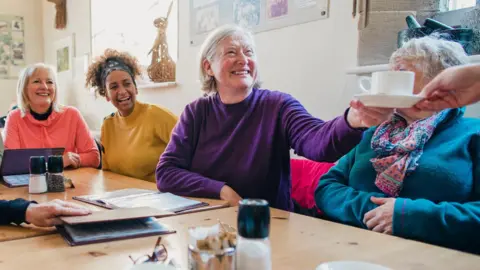 A group of women enjoying coffee at a community centre